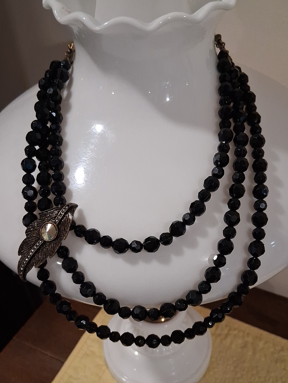 Black Three-Strand Beaded Necklace with Decorative Leaf Accent